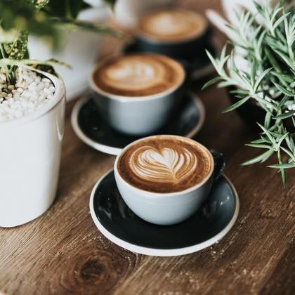 Two cups of coffee on a wooden table